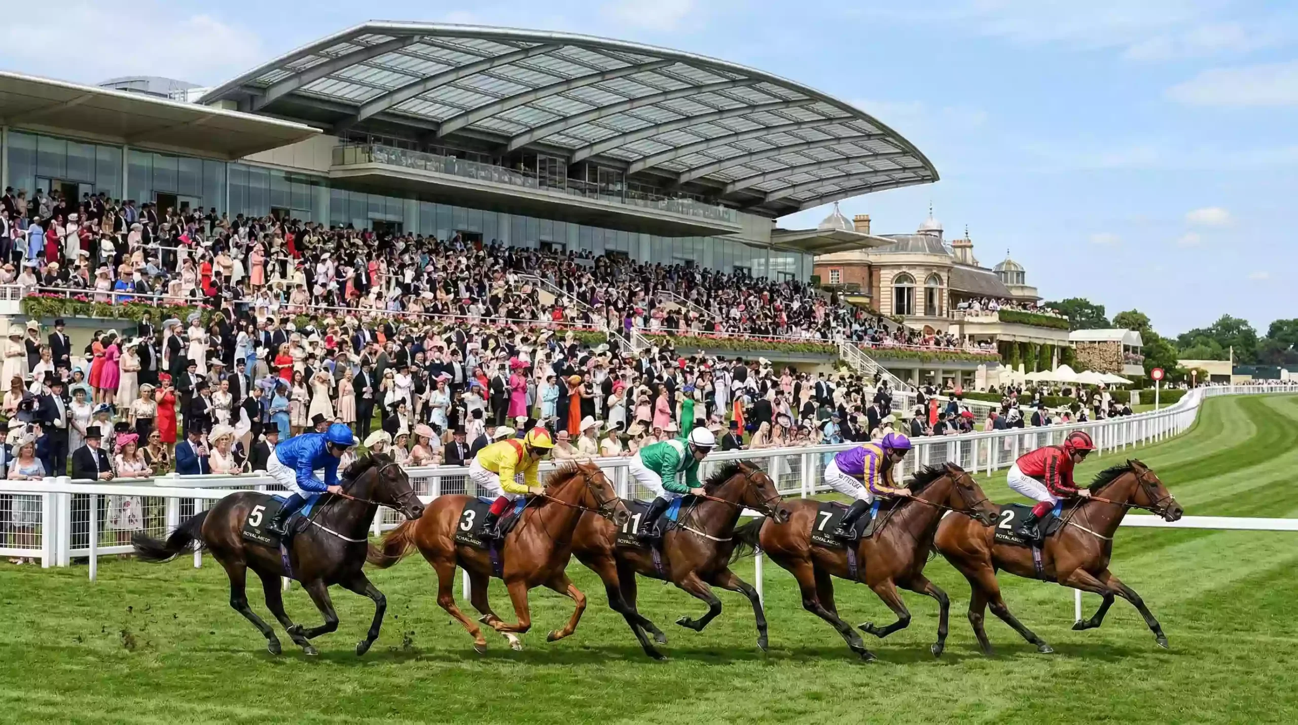 Elegant Royal Ascot racecourse grandstand with racegoers in formal attire